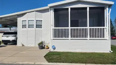 Relaxing screened porch overlooking clubhouse in fair lane acres, spy on the manager..[Florida Mobile Home]